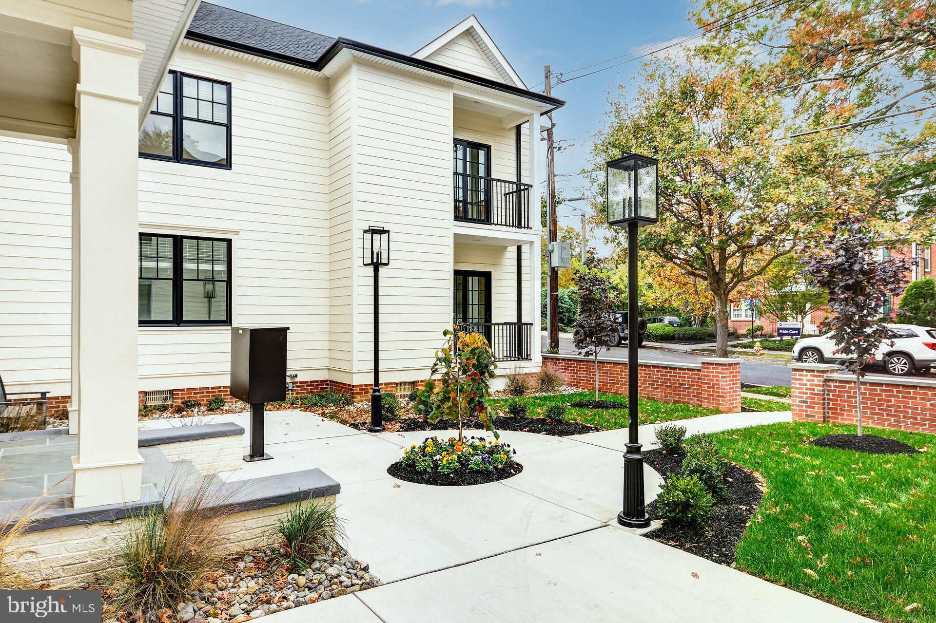 20 East Redman Avenue, Unit C Haddonfield, NJ 08033 - Photo 5 of 43 a front view of a house with garden and plants