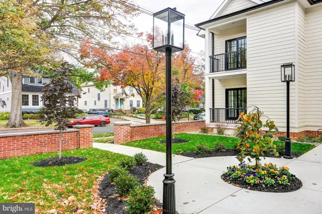 a front view of a house with a yard and fountain