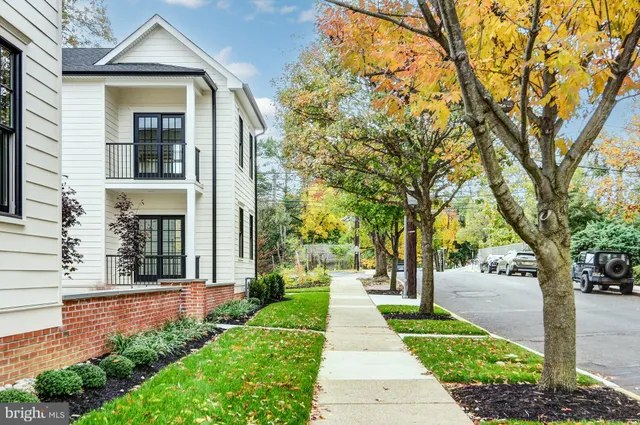a front view of a house with a yard and fountain