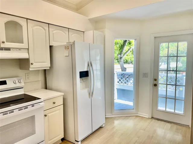 a kitchen with stainless steel appliances a refrigerator and a stove