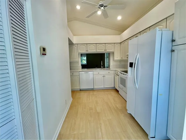 a kitchen with stainless steel appliances a refrigerator and a sink
