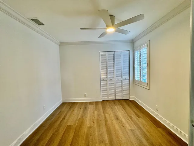 a view of room with wooden floor and fan