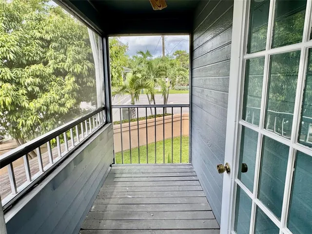 a view of balcony with wooden floor