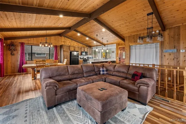 a living room with furniture a wooden floor and next to a window