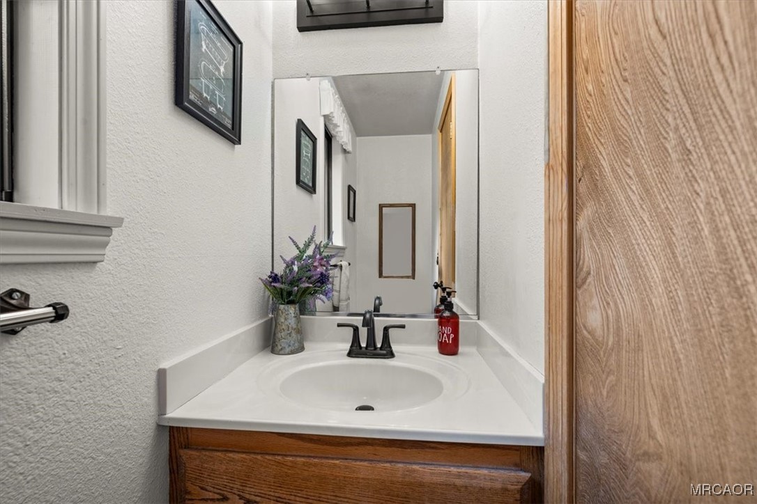 1414 Klamath Road Big Bear City, CA 92314 - Photo 11 of 28 a bathroom with a sink and a mirror