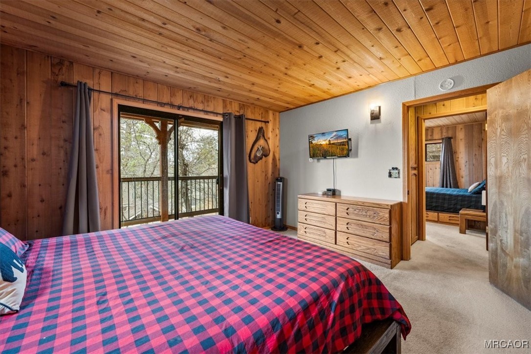 1414 Klamath Road Big Bear City, CA 92314 - Photo 13 of 28 a bedroom with a large bed and a large window