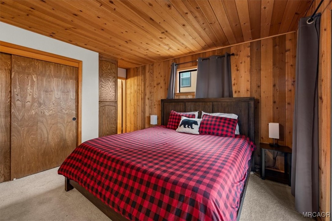 1414 Klamath Road Big Bear City, CA 92314 - Photo 14 of 28 a bedroom with a bed and wooden floor