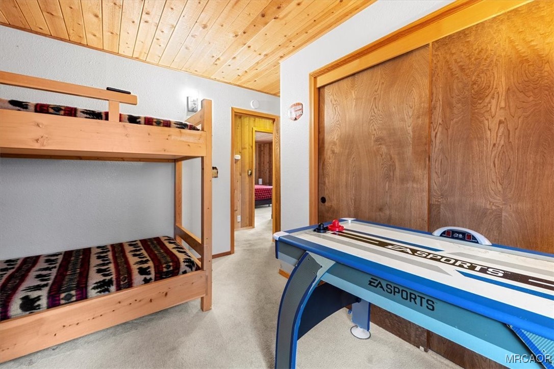 1414 Klamath Road Big Bear City, CA 92314 - Photo 22 of 28 a room with a bed and a dresser