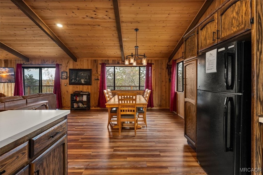 1414 Klamath Road Big Bear City, CA 92314 - Photo 6 of 28 a kitchen with stainless steel appliances granite countertop a refrigerator a stove top oven a dining table and chairs with wooden floor