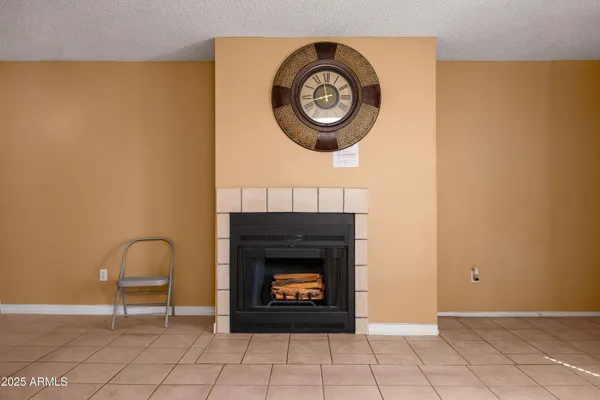 a living room with a fireplace and a table