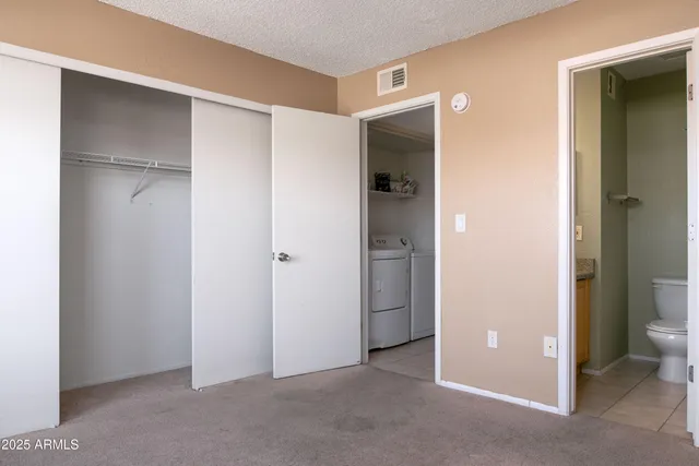 a view of an empty room with closet area