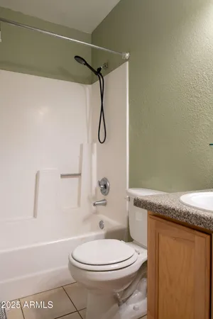 a bathroom with a granite countertop toilet sink and shower