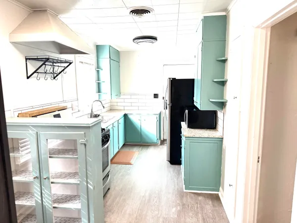 a house that has a tree in front of it