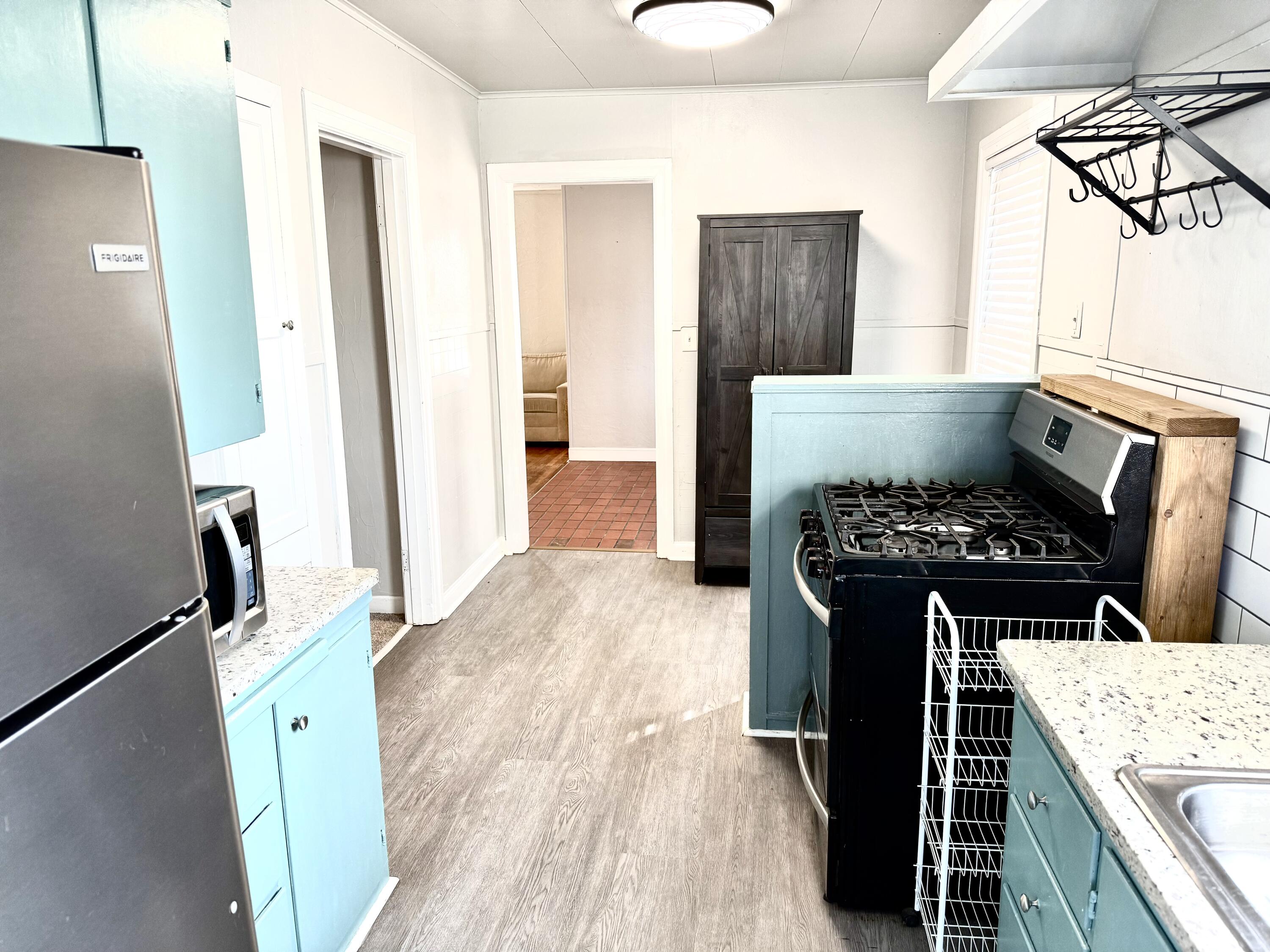 1906 25th Street Lubbock, TX 79411 - Photo 13 of 24 a kitchen with a stove a refrigerator and a sink