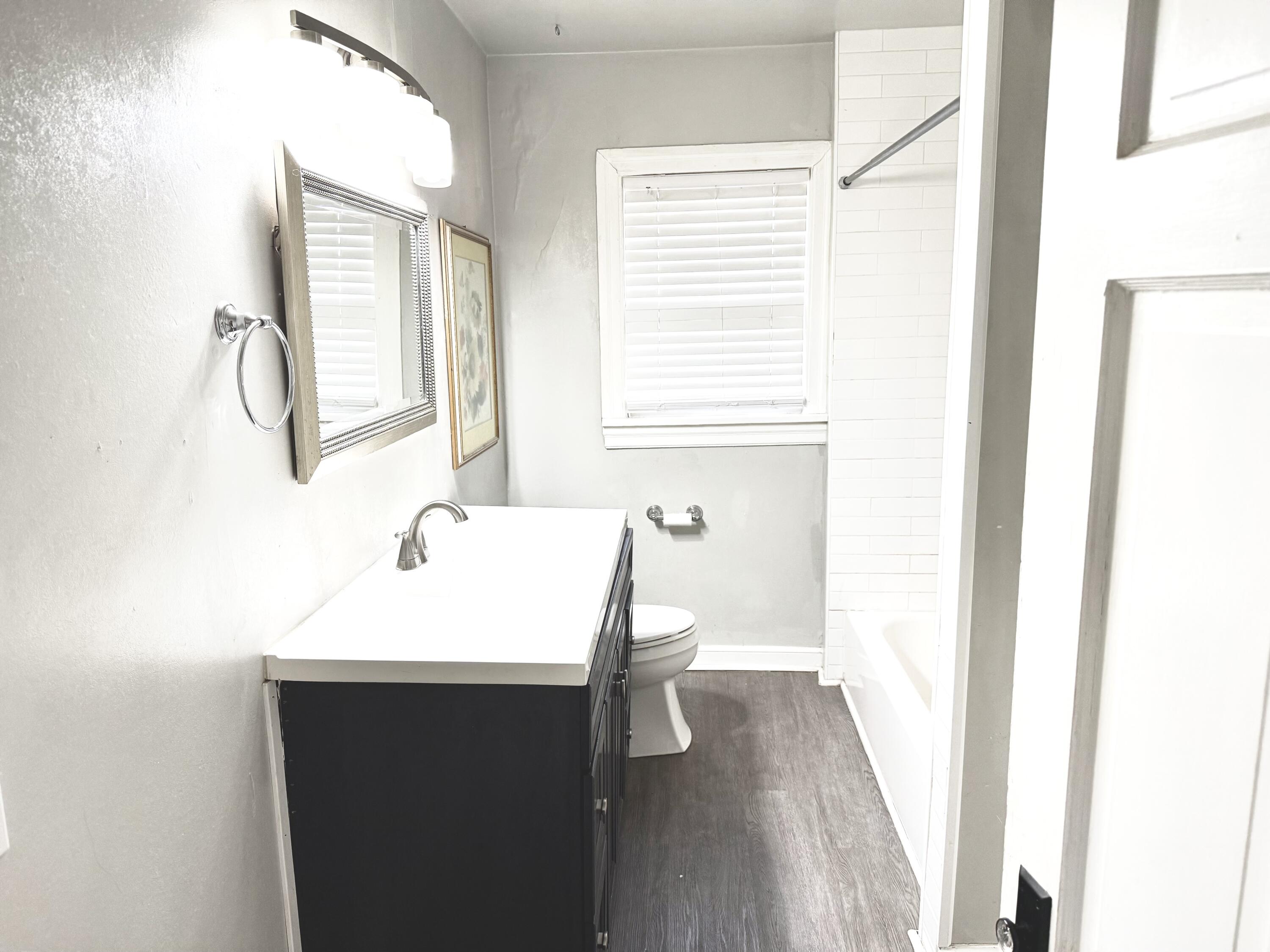 1906 25th Street Lubbock, TX 79411 - Photo 17 of 24 a bathroom with a sink and a mirror