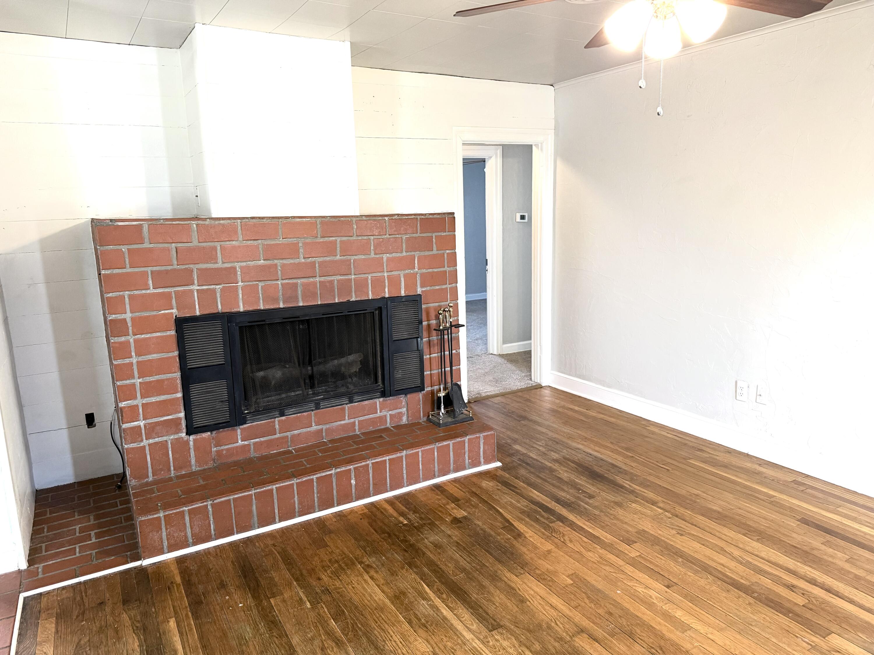 1906 25th Street Lubbock, TX 79411 - Photo 2 of 24 a view of an empty room with wooden floor and fireplace