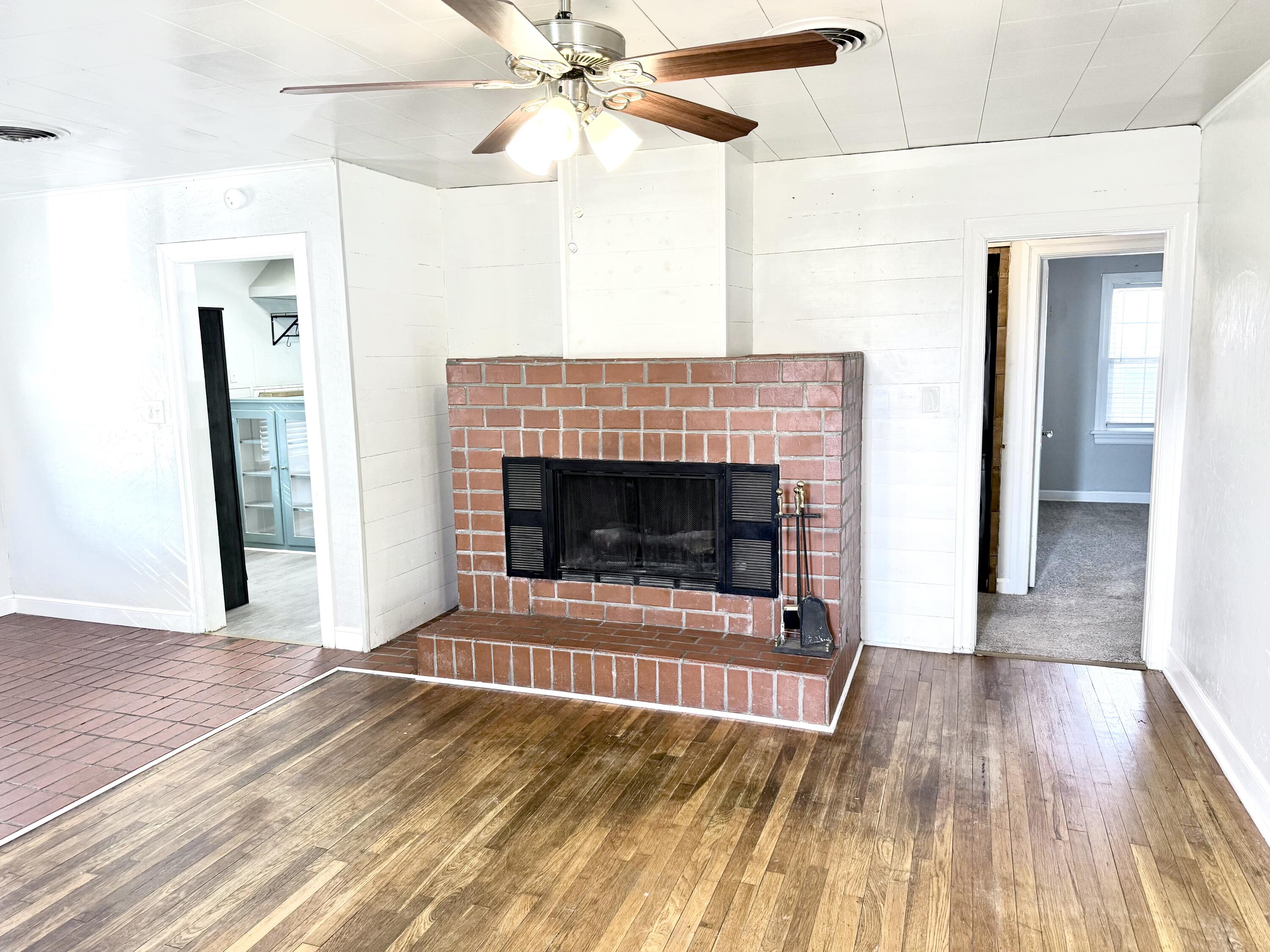 1906 25th Street Lubbock, TX 79411 - Photo 3 of 24 a living room with a fireplace and wooden floor
