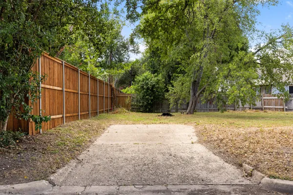 a backyard of a house with a trees
