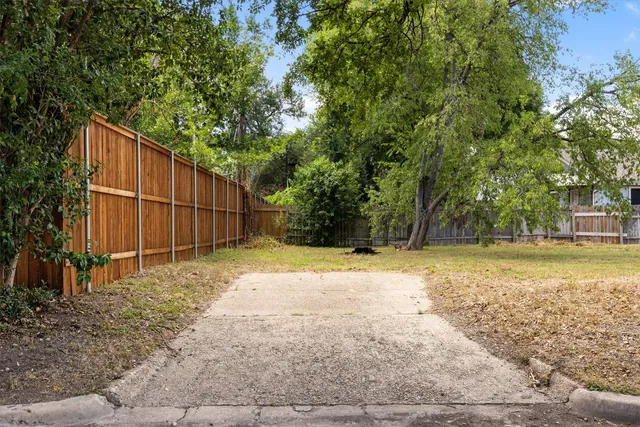 a backyard of a house with a trees