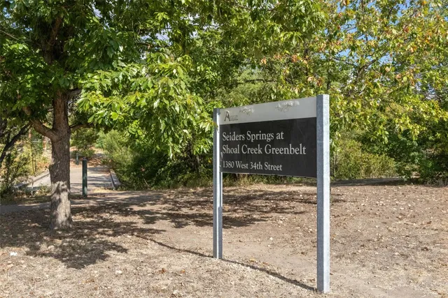 a sign board with wooden fence