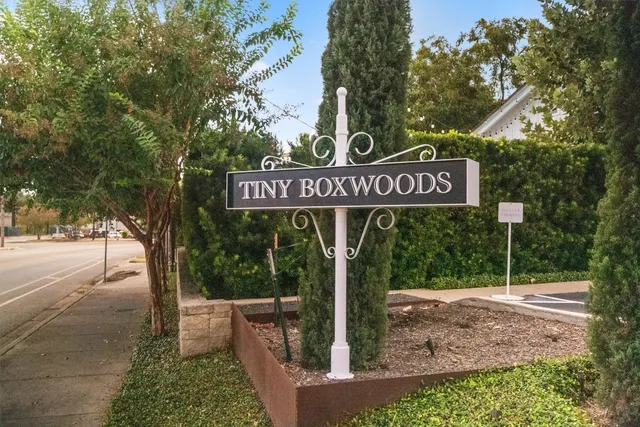 a street sign sitting on a sidewalk next to a road
