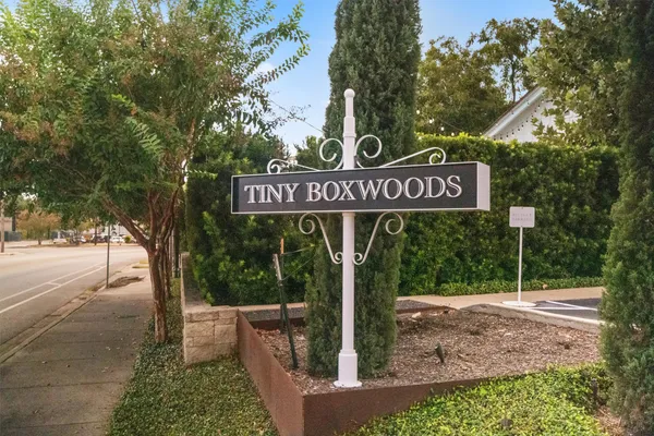 a street sign sitting on a sidewalk