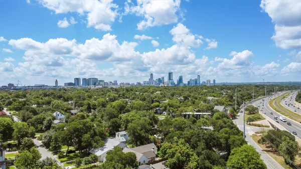 a view of a city with lush green forest