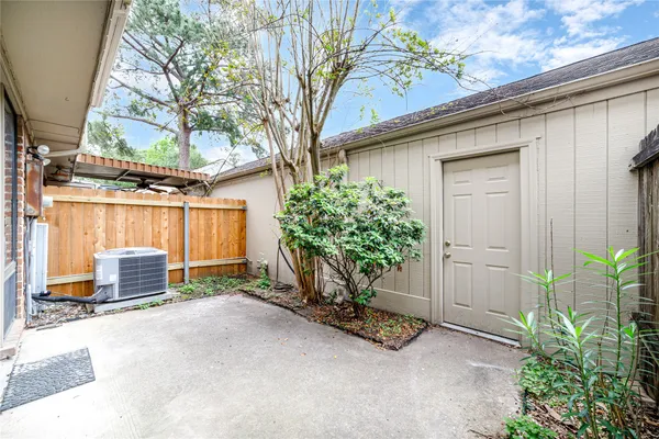 a view of a house with a garage and potted plants
