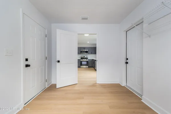 a view of hallway with wooden floor