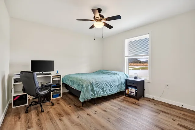 a bedroom with a bed and a window