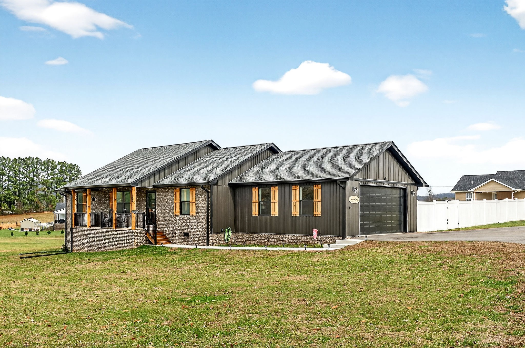 1004 North Spring Street Sparta, TN 38583 - Photo 2 of 30 a front view of a house with a garden and yard