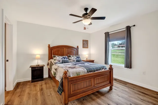 a bed sitting in a bedroom next to a window
