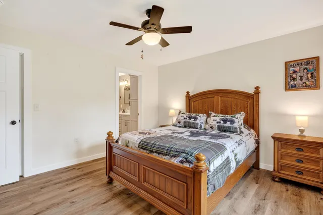 a bedroom with a bed and wooden floor