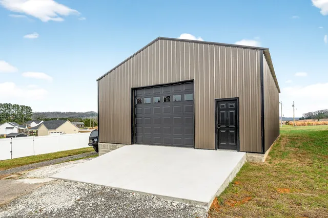 a view of a house with a yard and garage