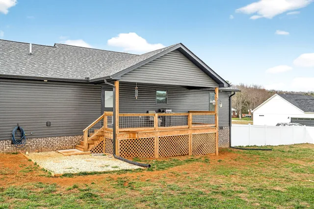 a view of an house with backyard and road
