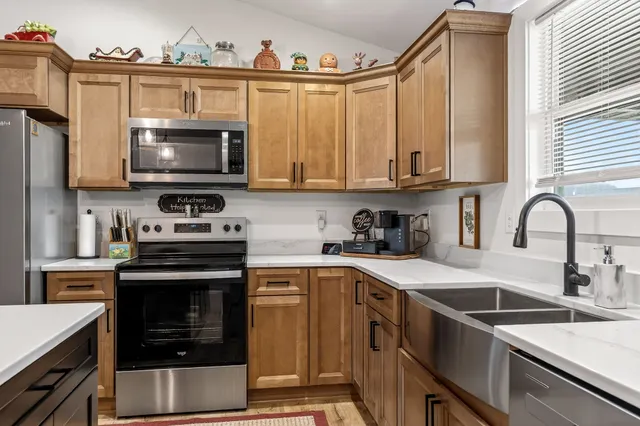 a kitchen with a sink a stove and cabinets