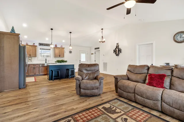 a living room with furniture and kitchen view