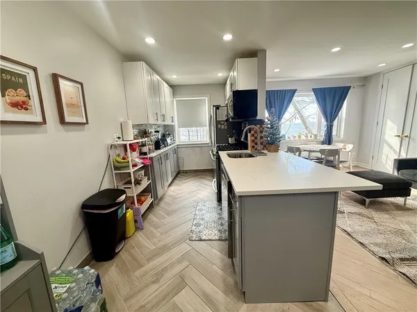 a kitchen with a sink a stove and a refrigerator