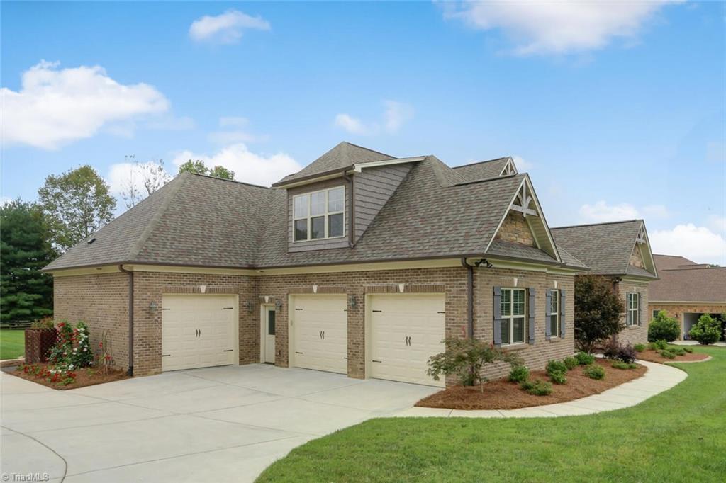 8501 Billet Place Oak Ridge, NC 27310 - Photo 2 of 30 Oversized 3 car garage with extra room for parking and turning around.