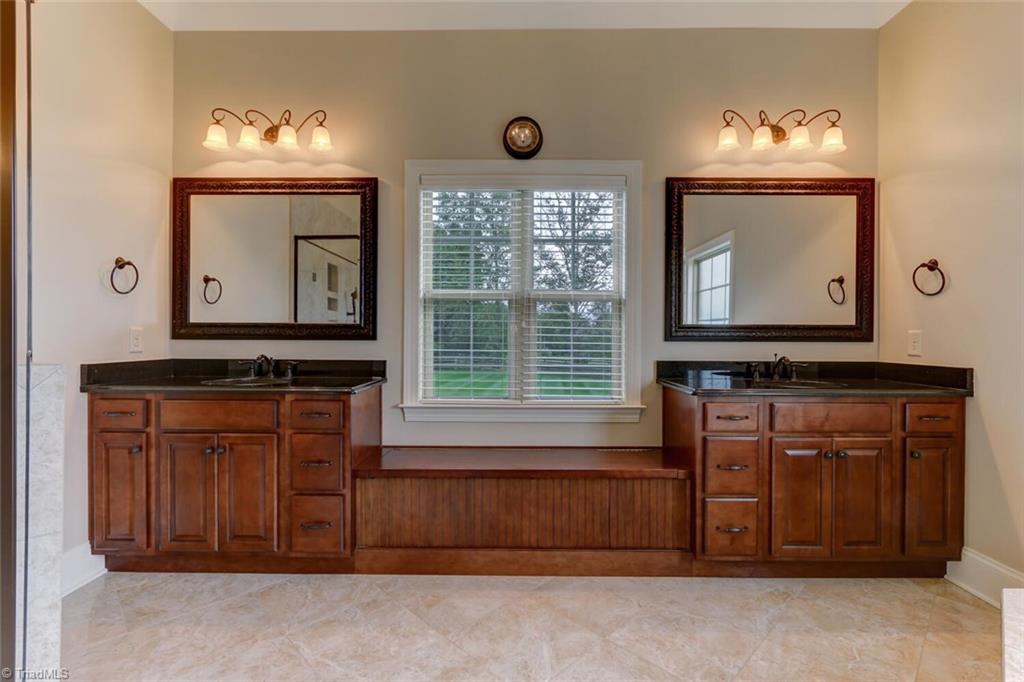 8501 Billet Place Oak Ridge, NC 27310 - Photo 11 of 30 The owner's ensuite bath is gigantic! It offers great natural light and an awesome seated bench provides extra storage.