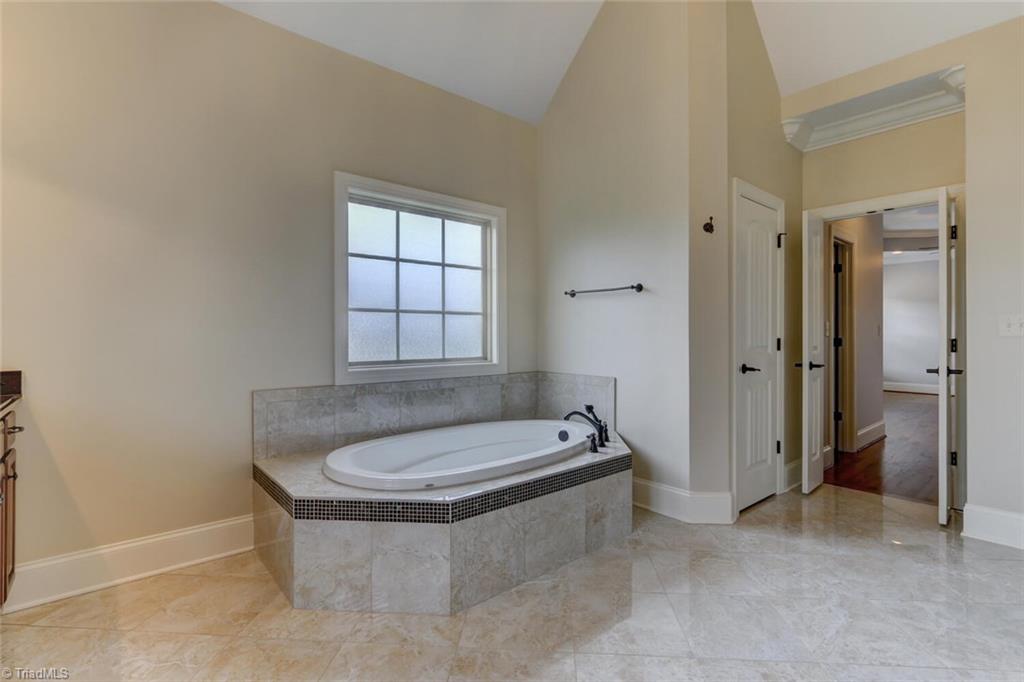 8501 Billet Place Oak Ridge, NC 27310 - Photo 12 of 30 A large soaking tub is the perfect end to a stressful day.