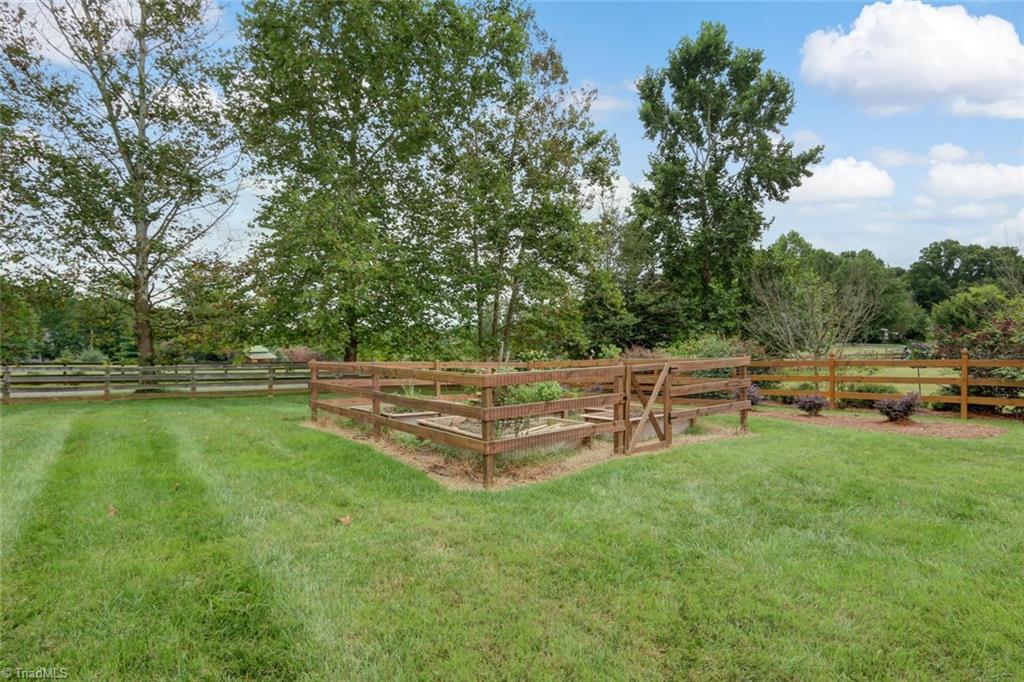 8501 Billet Place Oak Ridge, NC 27310 - Photo 24 of 30 Raised gardens with fencing to protect the vegetables from the wildlife.