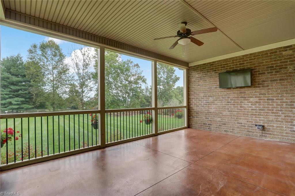 8501 Billet Place Oak Ridge, NC 27310 - Photo 26 of 30 This is the screened covered porch with stained concrete floor and TV ready!!!