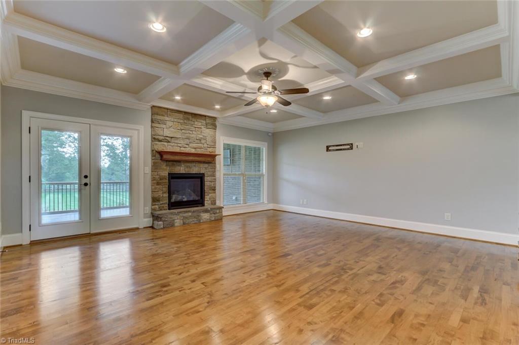 8501 Billet Place Oak Ridge, NC 27310 - Photo 5 of 30 Huge great room with coffered ceiling, recessed lights and stacked stone fireplace.