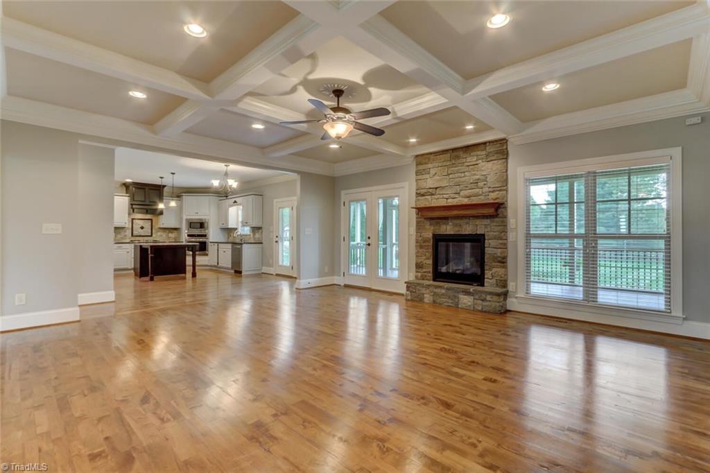 8501 Billet Place Oak Ridge, NC 27310 - Photo 6 of 30 Great room also opens up to the kitchen and the double doors lead out to the rear covered porch.