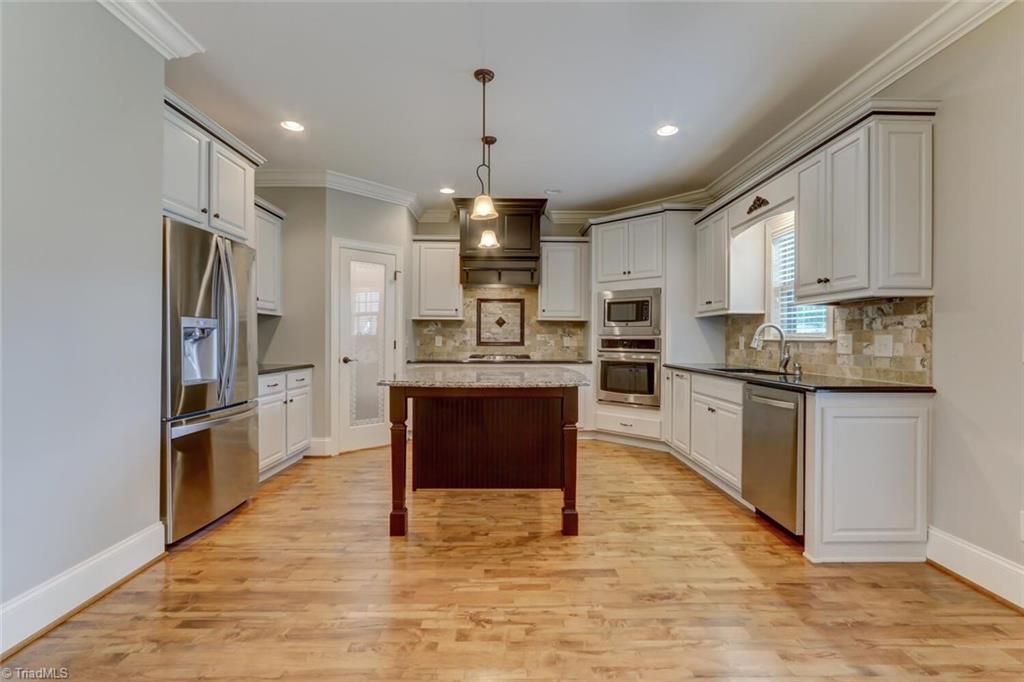 8501 Billet Place Oak Ridge, NC 27310 - Photo 7 of 30 The perfect u shaped kitchen with stainless steel appliances and huge enter island.
