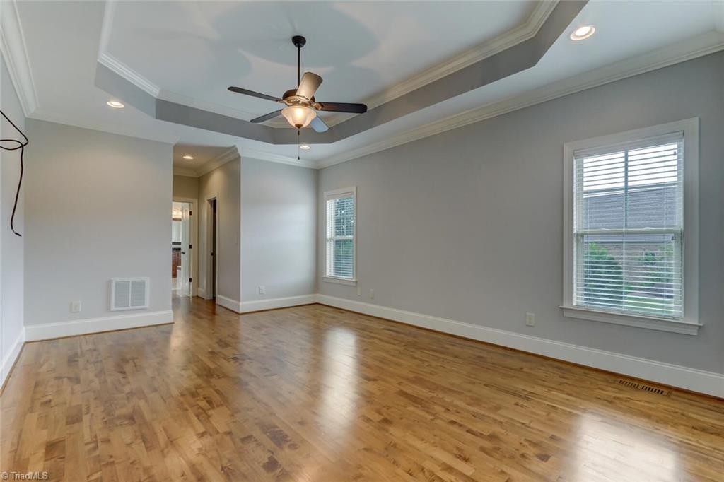 8501 Billet Place Oak Ridge, NC 27310 - Photo 9 of 30 Large owner's suite with tray ceiling, walk in closets and hardwood floors.
