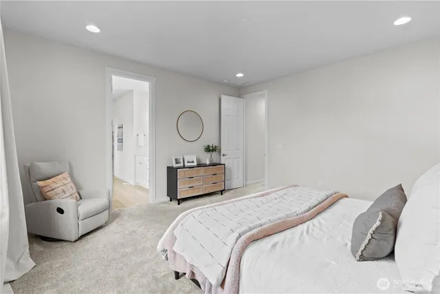 a bedroom with a bed a mirror and lamp