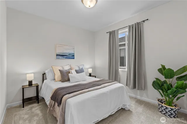 a bedroom with a bed and a potted plant