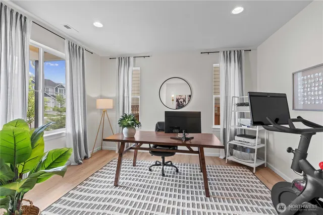a view of a livingroom with workspace and a window